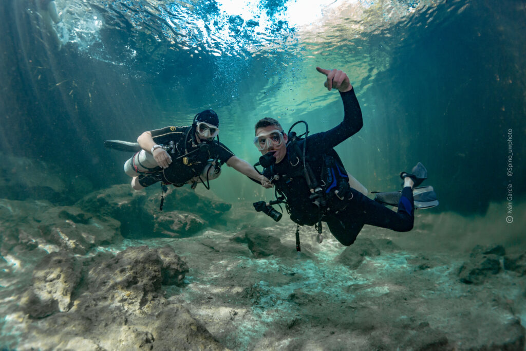 Triton Diving adventurers giving thumbs-up while diving in the clear waters of Casa Cenote